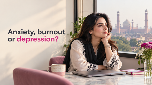 Pakistani woman seated beside a closed laptop, reflecting on anxiety, burnout and depression.