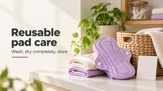 Clean folded reusable menstrual pads beside a small laundry basket, illustrating washing, drying and storage.